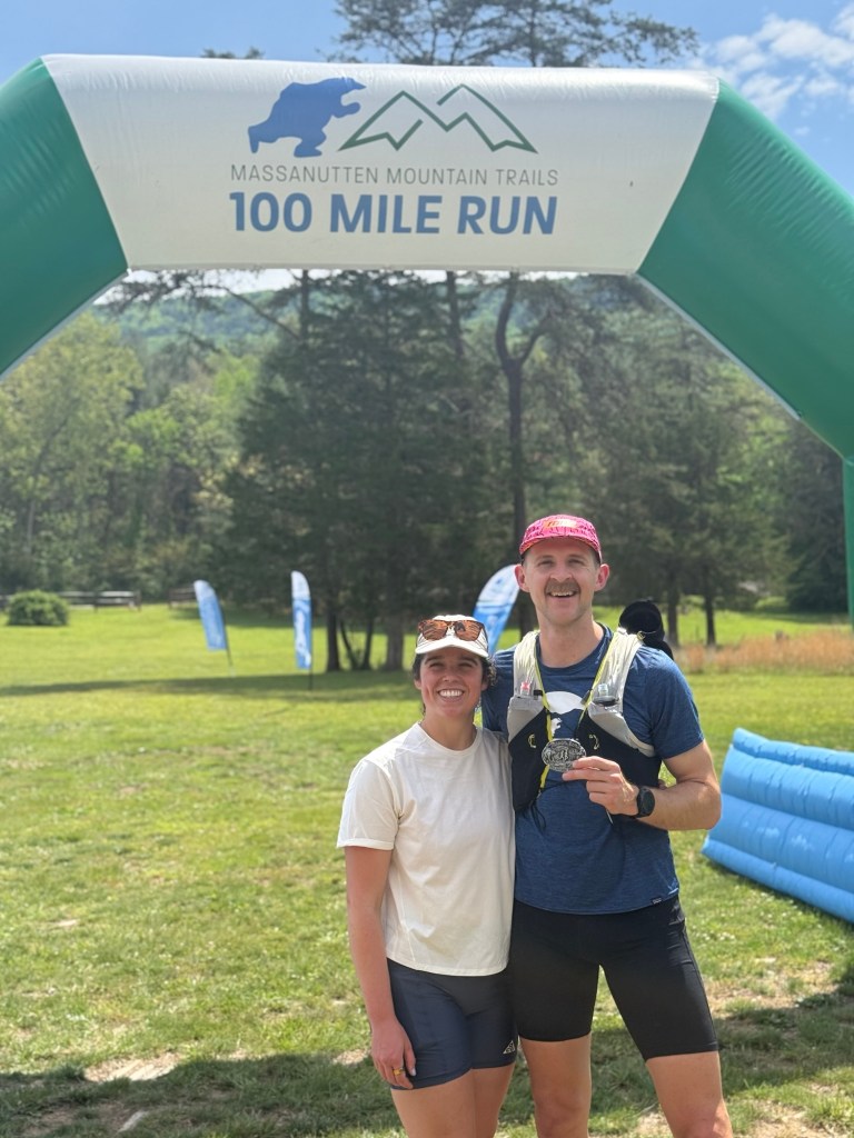 Patrick and Juliana under the finishing arch of MMT.